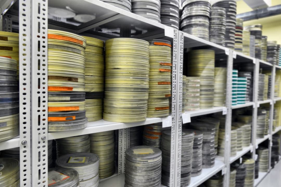 Film archive shelves with hundreds of film canisters